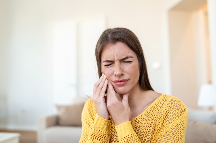 photo tooth pain and dentistry beautiful young woman suffering from terrible strong teeth pain touching cheek with hand female feeling painful toothache dental care health concept high resolution